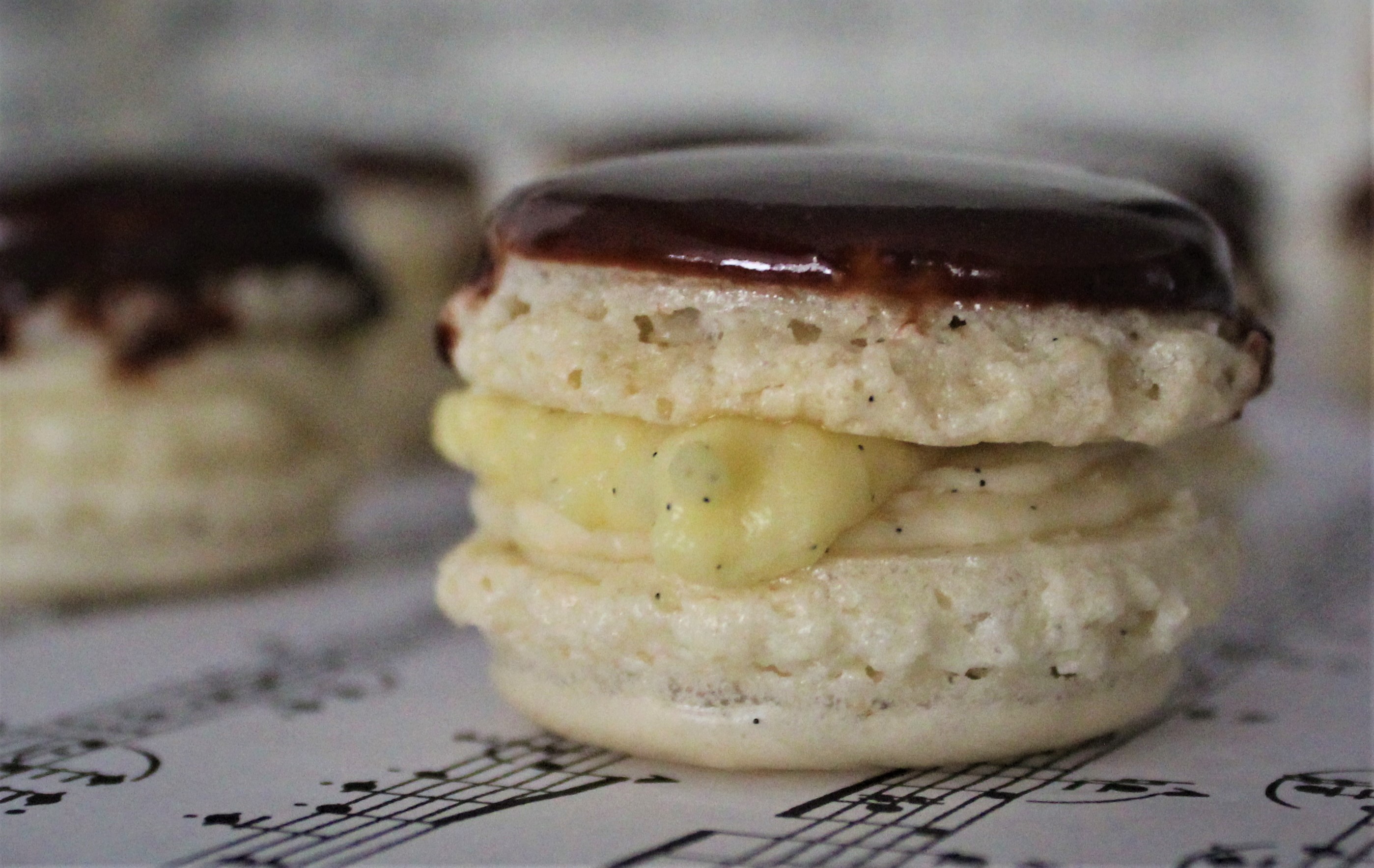 Boston Cream Pie Macarons from Poeme Macarons perched on classical music.