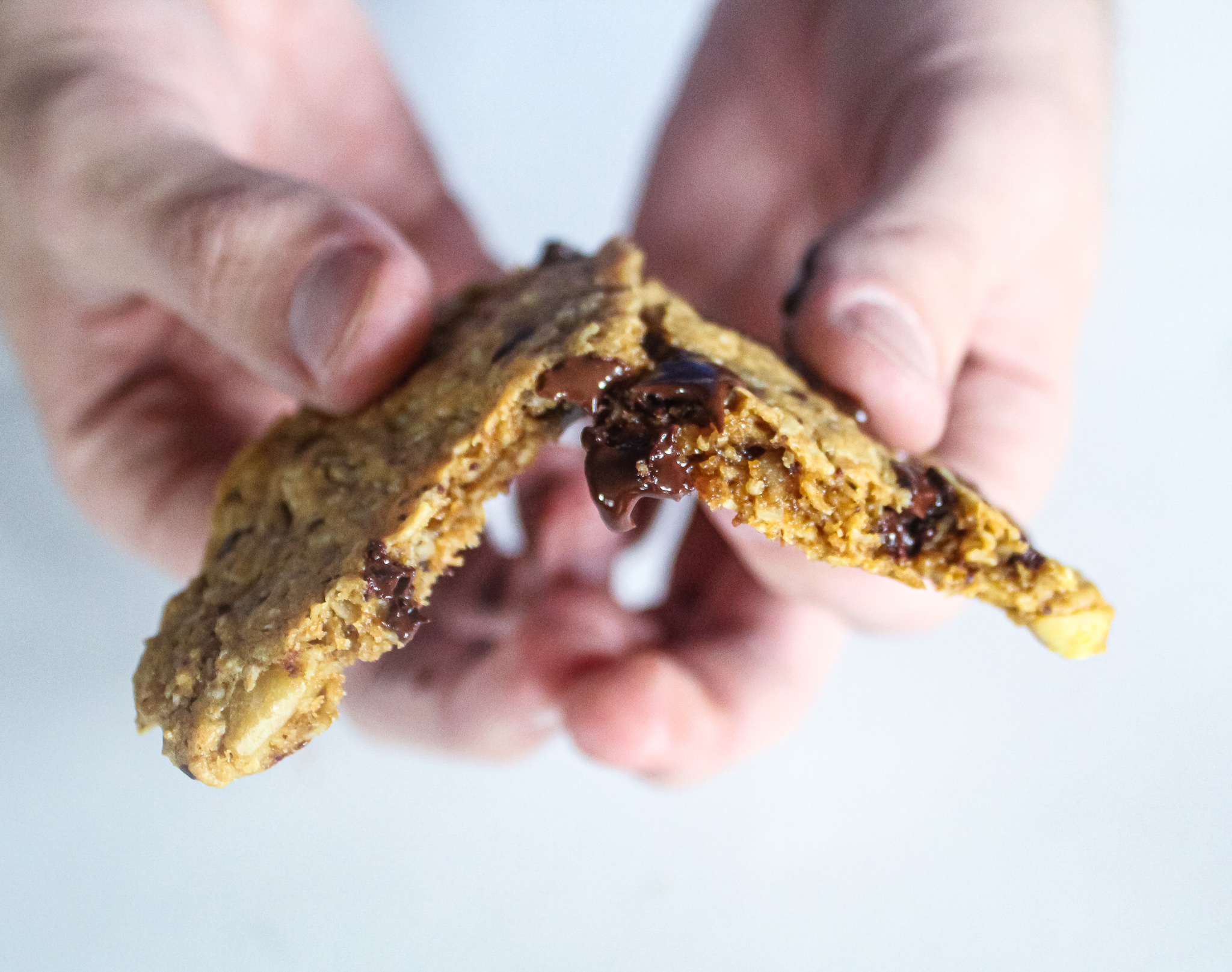 breaking apart a delicious monster cookie